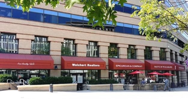 Office building with red awnings and patio