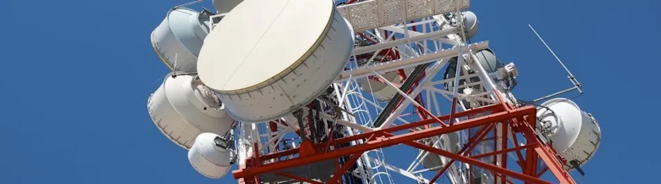 Red lattice tower with large microwave dishes