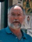 Man in blue shirt with beard.