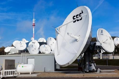 white satellite dishes at a ground communications station