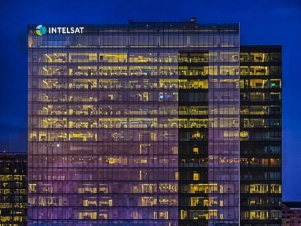 Glass office tower lit at night