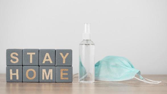 Blocks spelling STAY HOME with mask and sanitizer