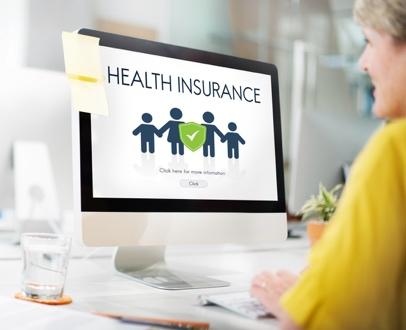 Woman viewing health insurance webpage on monitor