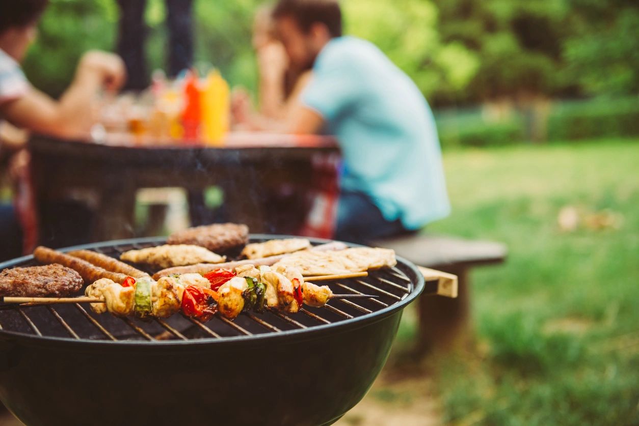 Skewers and burgers on outdoor grill