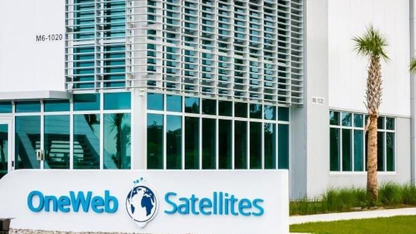 Sign for Eutelsat Satellites in front of a modern glass building.