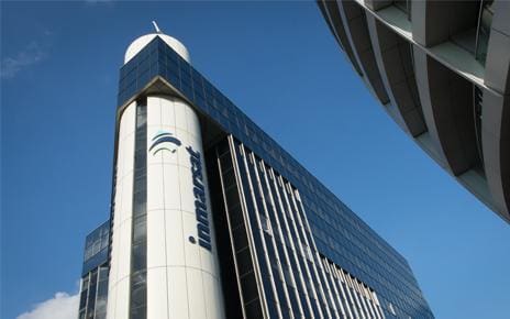 Modern high-rise building with a clear blue sky.