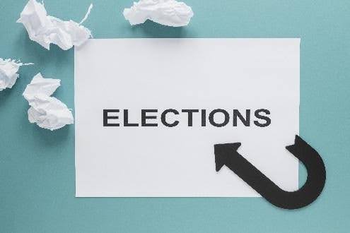 White card "ELECTIONS" with arrow, crumpled papers