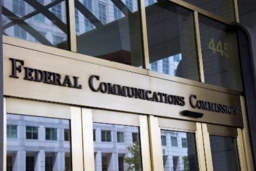 Entrance of a government building labeled General Communications Commission.