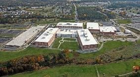 Aerial view of a large school complex with sports fields and parking lots.
