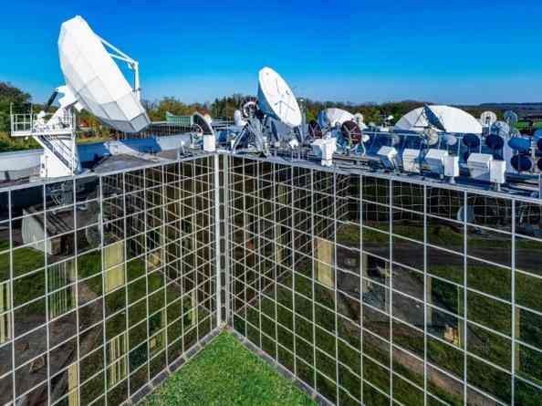 Solar panels arranged in a corner formation under clear blue skies.
