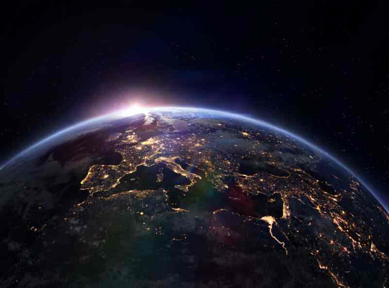 View of Earth from space showing city lights and the horizon.