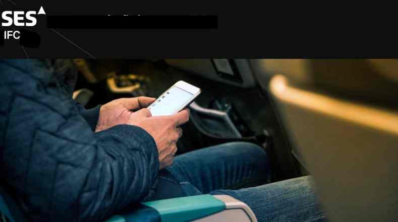 Person using smartphone while sitting in a car.