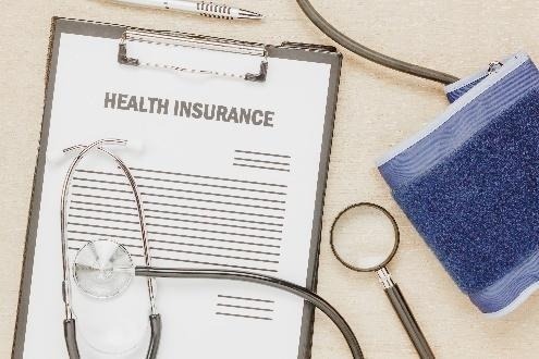 Health insurance clipboard with stethoscope and cuff