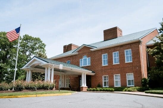 Entrance of a red brick building under a clear sky.