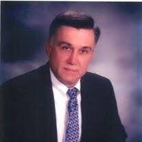 Professional portrait of a man in a suit and tie.