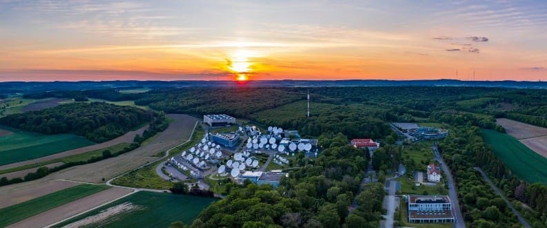 Sunset over satellite dishes in rural landscape