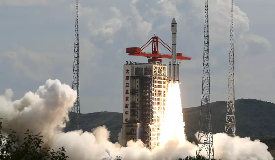 Rocket launching amidst smoke and clouds.