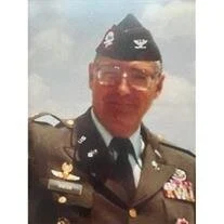 Man in military uniform with medals.