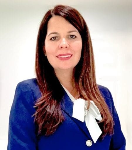 Woman in blue suit, white background.
