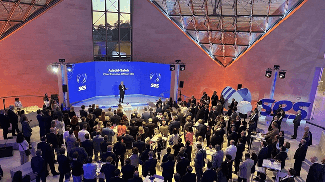 Crowd attending an SES corporate event presentation.