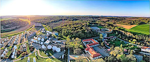 Satellite facility surrounded by lush greenery.