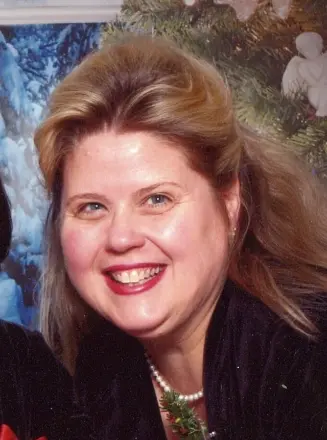 Smiling woman with festive holiday background.