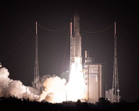 Ariane rocket liftoff at night from launch pad