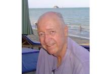 Man smiling by the beach.