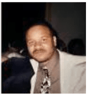 Man in suit with patterned tie.