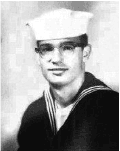 Young man in sailor uniform and glasses.