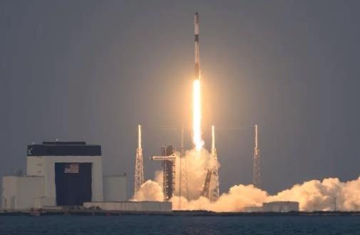 Rocket launching from a coastal space center.