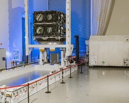 Spacecraft in industrial assembly area.