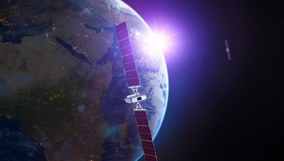 Satellite orbiting Earth with bright sunlight.