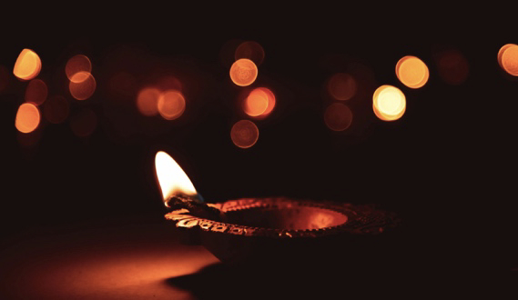 Oil lamp with a soft, glowing flame.