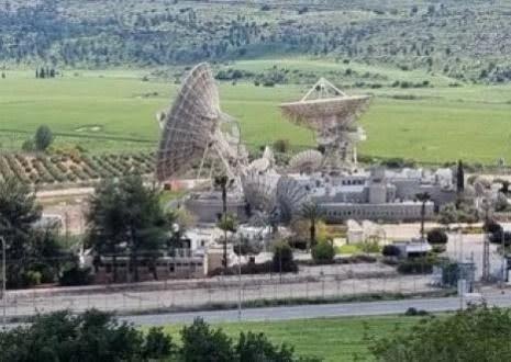 Satellite dishes in a rural landscape setting.