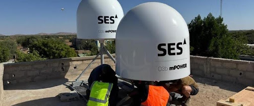 Satellite dishes being installed on rooftop.