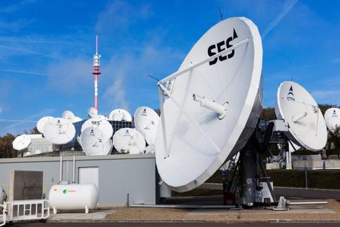 Satellite dishes and communication equipment under sky.