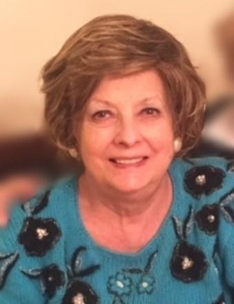 Smiling older woman in blue floral sweater