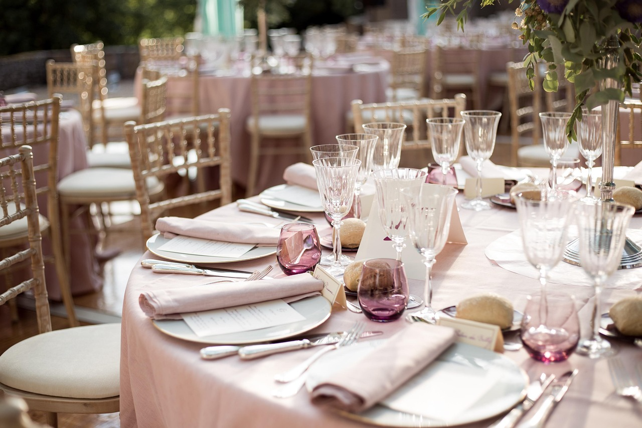 Elegant pink-themed outdoor wedding reception setup.