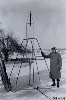 Man with early rocket in snowy landscape.