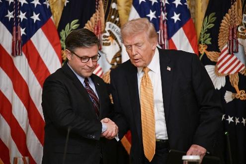 Two men shaking hands at an event.