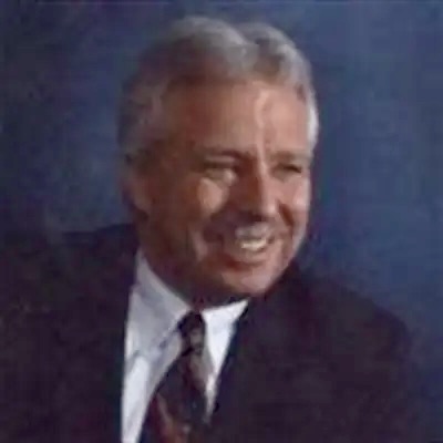 Smiling man in a suit and tie.