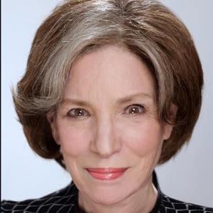 Headshot of smiling older woman with short hair