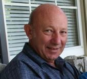 Smiling older man sitting on porch