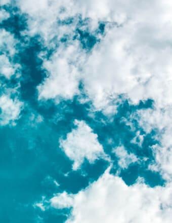 Fluffy white clouds in blue sky.