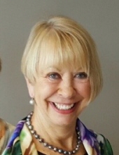 Smiling woman with short blonde hair.