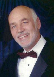 Smiling older man in tuxedo and bow tie
