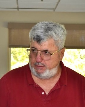 Man in red shirt with glasses.