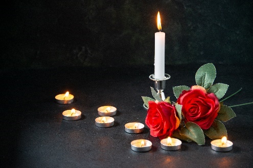 Candles and roses on a dark background.