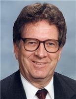 Smiling man wearing glasses and suit